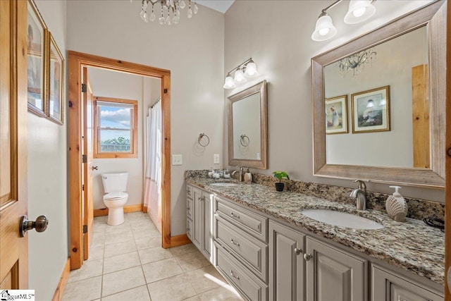 bathroom featuring tile patterned floors, vanity, and toilet