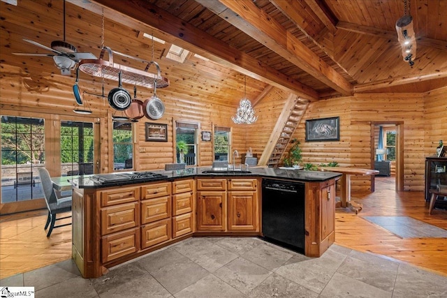 kitchen with sink, decorative light fixtures, black appliances, and a kitchen island