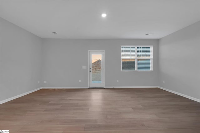 spare room with light hardwood / wood-style floors