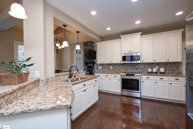 kitchen with stainless steel appliances, white cabinetry, and sink