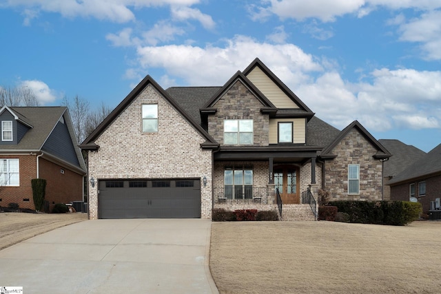 craftsman inspired home with a garage, central AC, and covered porch