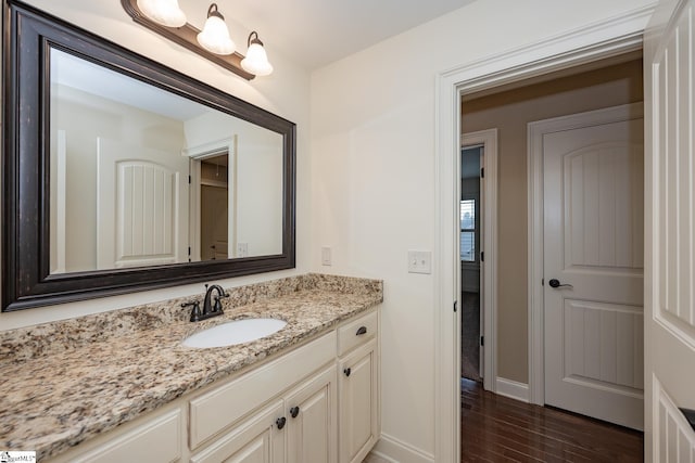 bathroom with vanity and wood-type flooring