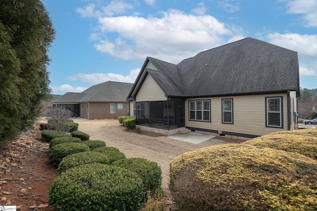 back of property featuring a sunroom and a patio area