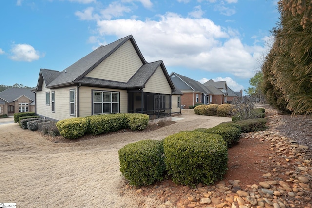 view of property exterior featuring a sunroom