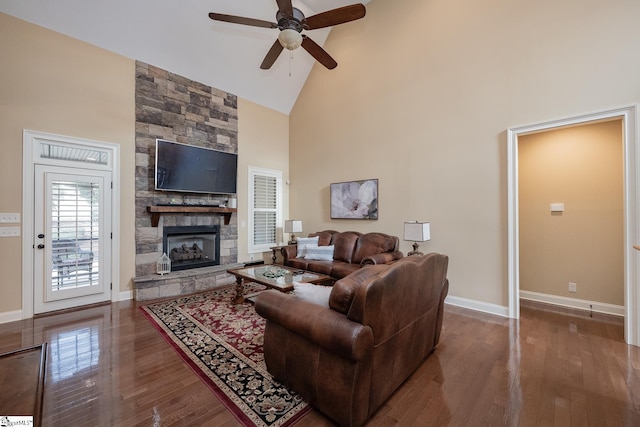 living room featuring hardwood / wood-style floors, a fireplace, high vaulted ceiling, and ceiling fan