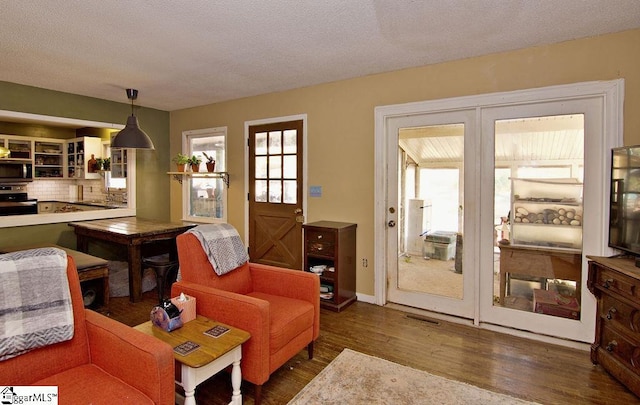 living room with dark wood-type flooring and a textured ceiling