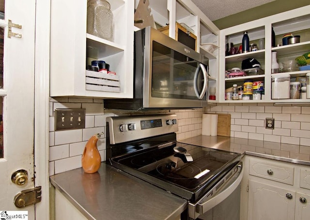 kitchen with tasteful backsplash, stainless steel appliances, and white cabinets