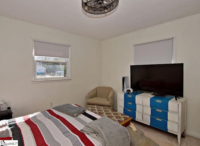 carpeted bedroom featuring a textured ceiling