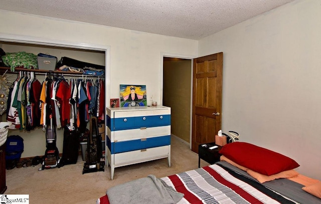 carpeted bedroom featuring a closet and a textured ceiling