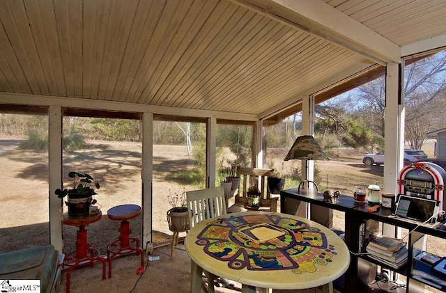 sunroom / solarium featuring wood ceiling and beamed ceiling