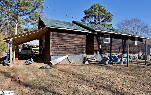 view of home's exterior with a lawn and central air condition unit