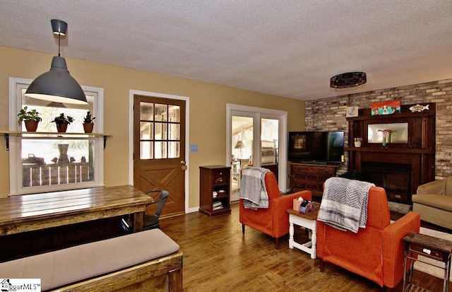 living room with dark hardwood / wood-style floors and a textured ceiling