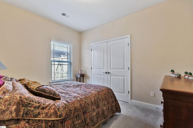 carpeted bedroom featuring a closet