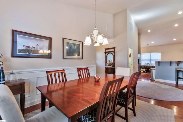 dining area with hardwood / wood-style flooring and a chandelier