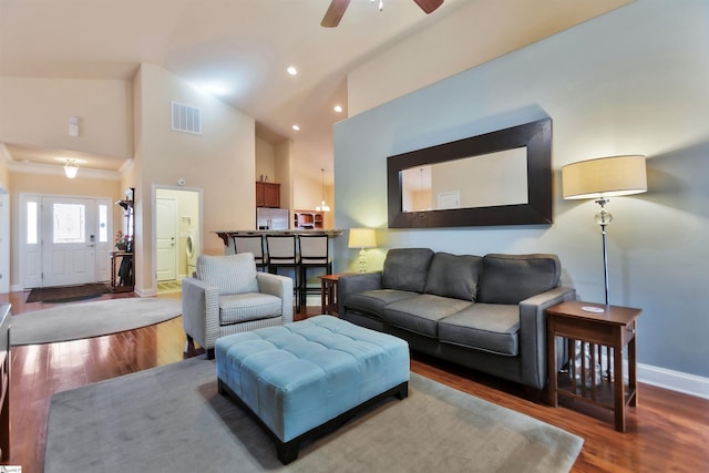 living room with ceiling fan, high vaulted ceiling, and hardwood / wood-style floors