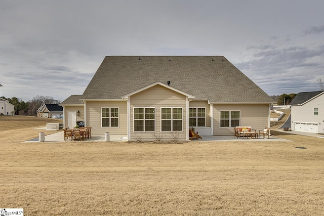 back of property with a patio area and a lawn