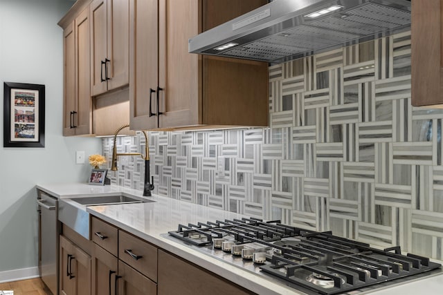 kitchen with stainless steel appliances, radiator, sink, and backsplash