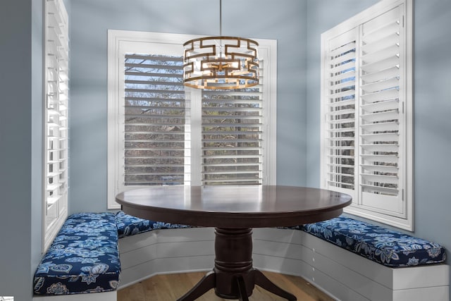 dining room with hardwood / wood-style flooring and a notable chandelier