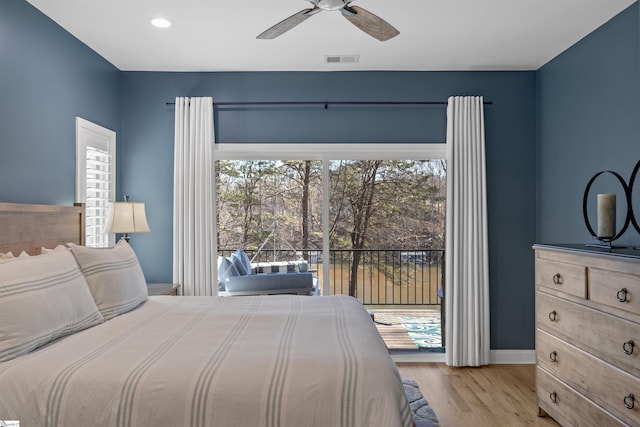 bedroom featuring multiple windows, access to outside, ceiling fan, and light hardwood / wood-style flooring