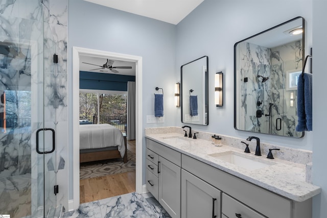 bathroom with ceiling fan, vanity, and an enclosed shower