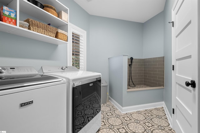 laundry room with washing machine and dryer and light tile patterned floors