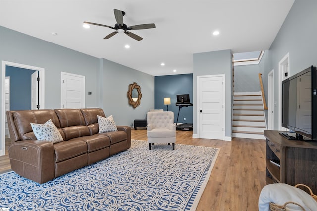 living room featuring ceiling fan and light wood-type flooring