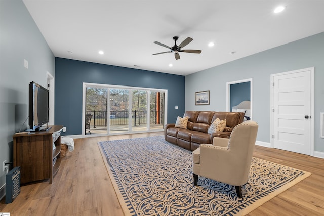 living room featuring ceiling fan and light wood-type flooring