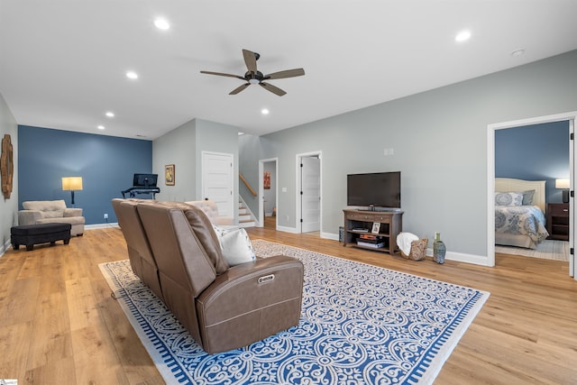 living room with ceiling fan and light hardwood / wood-style floors