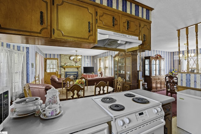 kitchen with refrigerator, an inviting chandelier, electric range, a fireplace, and decorative light fixtures