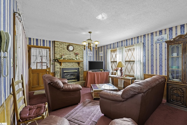 carpeted living room featuring a fireplace, a textured ceiling, and a notable chandelier