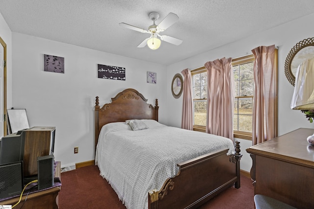 carpeted bedroom with ceiling fan and a textured ceiling