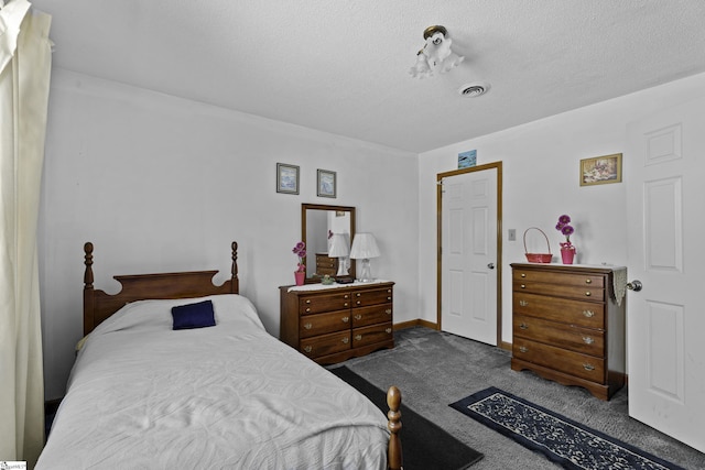 carpeted bedroom with a textured ceiling