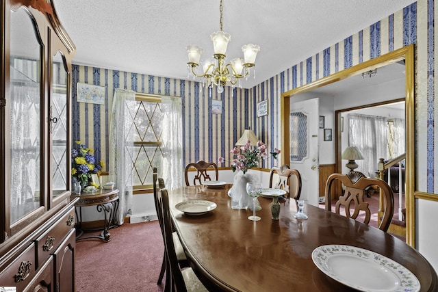 dining space with carpet, a wealth of natural light, a notable chandelier, and a textured ceiling