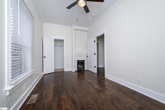 interior space with ornamental molding, dark wood-type flooring, and ceiling fan