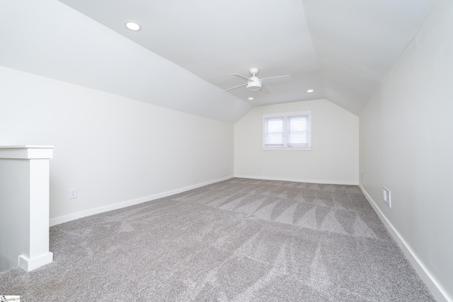 additional living space featuring vaulted ceiling, carpet flooring, and ceiling fan