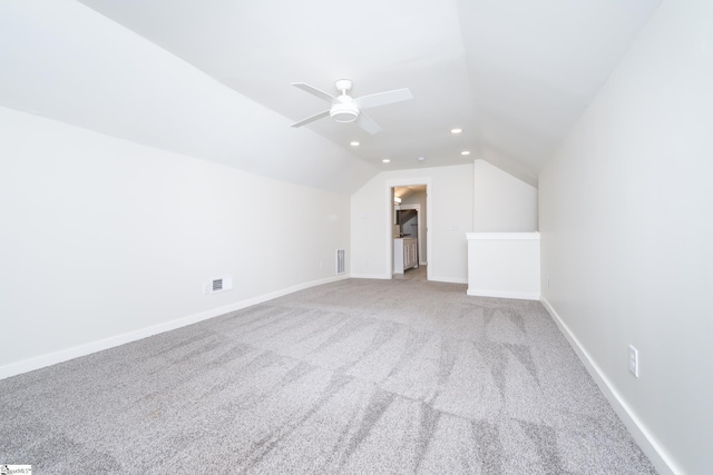 additional living space with carpet floors, vaulted ceiling, and ceiling fan