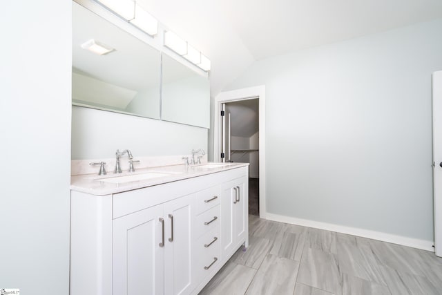 bathroom with lofted ceiling and vanity