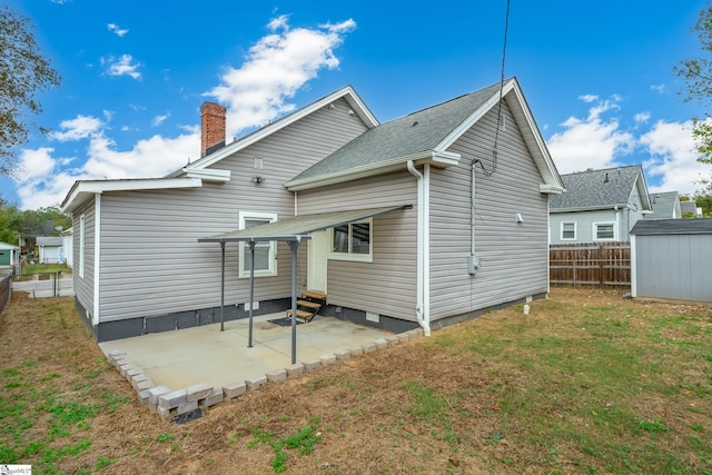 back of house with a yard and a patio area