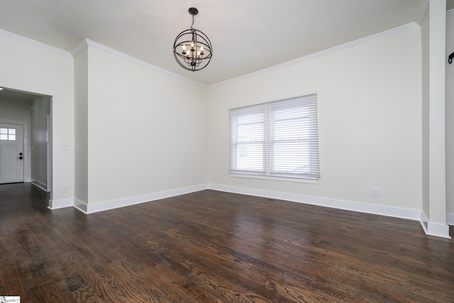 empty room with crown molding, dark hardwood / wood-style floors, and a chandelier