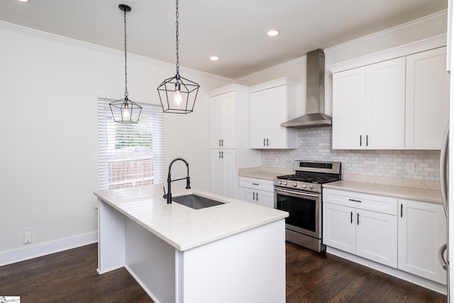 kitchen with wall chimney range hood, sink, a kitchen island with sink, white cabinetry, and stainless steel gas range oven