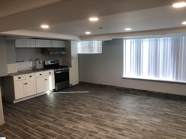 kitchen featuring white cabinetry, dark hardwood / wood-style flooring, decorative backsplash, and stainless steel gas range oven