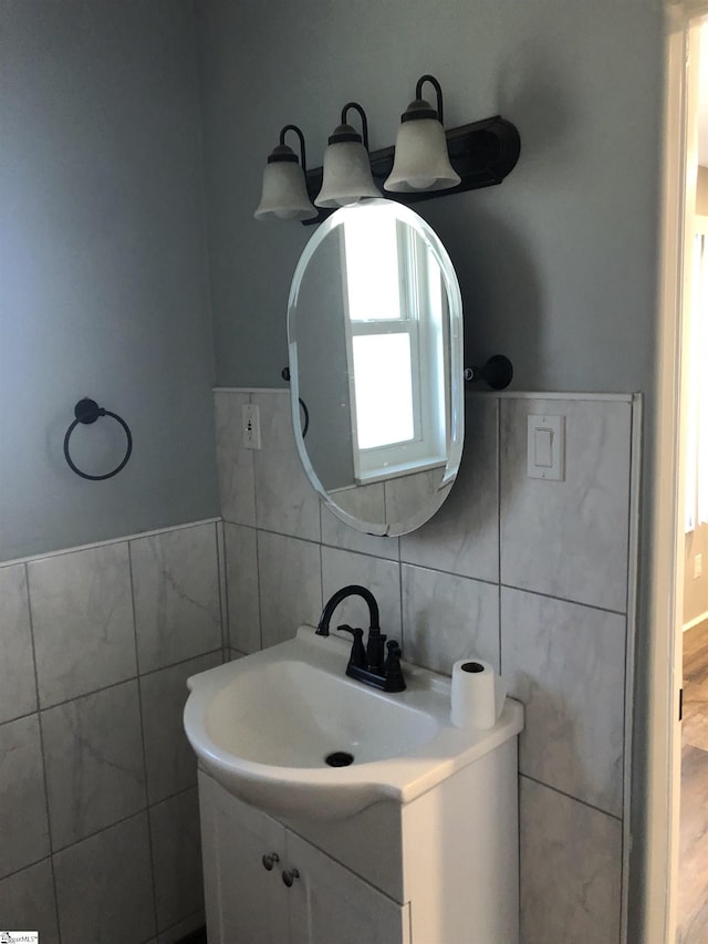 bathroom featuring vanity and tile walls