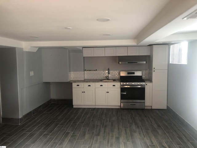 kitchen featuring tasteful backsplash, stainless steel gas range oven, sink, and white cabinetry