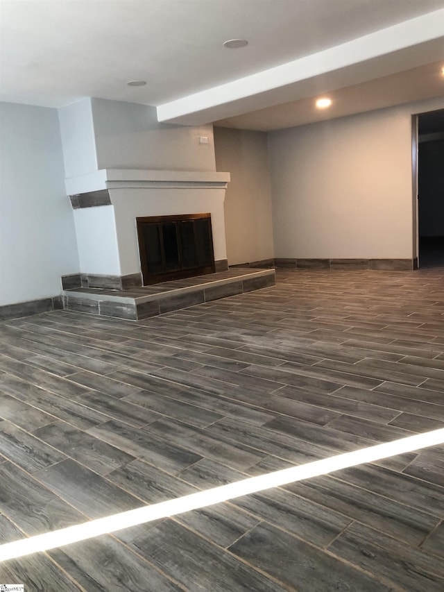 unfurnished living room featuring dark hardwood / wood-style floors