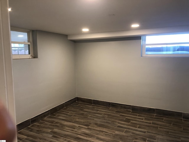 basement with dark hardwood / wood-style flooring