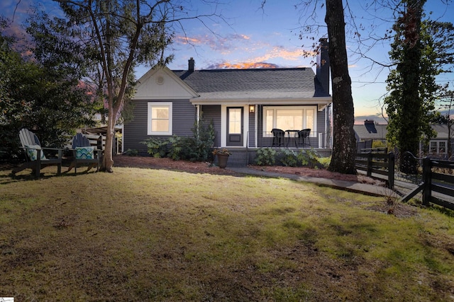 view of front of house featuring a yard and covered porch