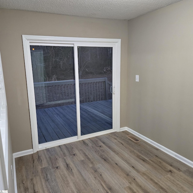 interior space with hardwood / wood-style floors and a textured ceiling