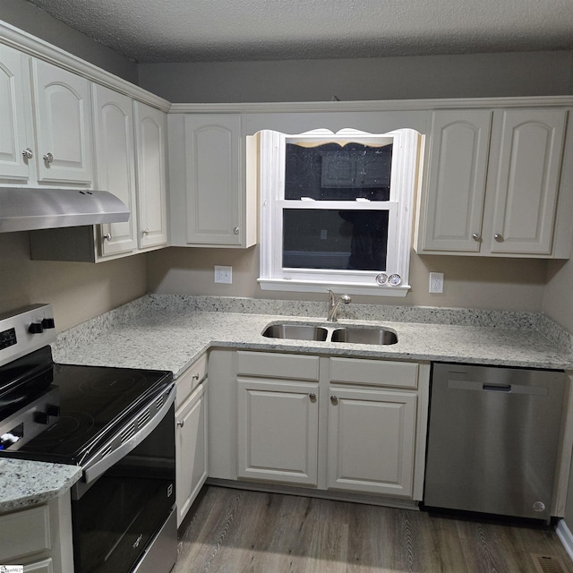 kitchen featuring stainless steel appliances, dark hardwood / wood-style flooring, sink, and white cabinets