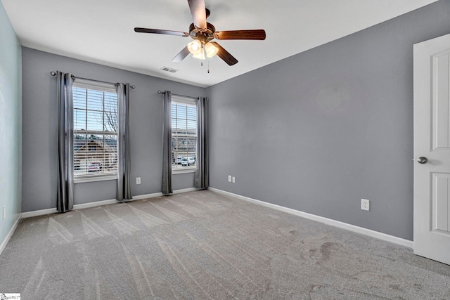 carpeted spare room featuring ceiling fan