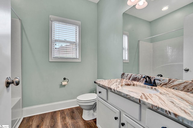 full bathroom featuring hardwood / wood-style flooring, vanity, shower / bathtub combination, and toilet